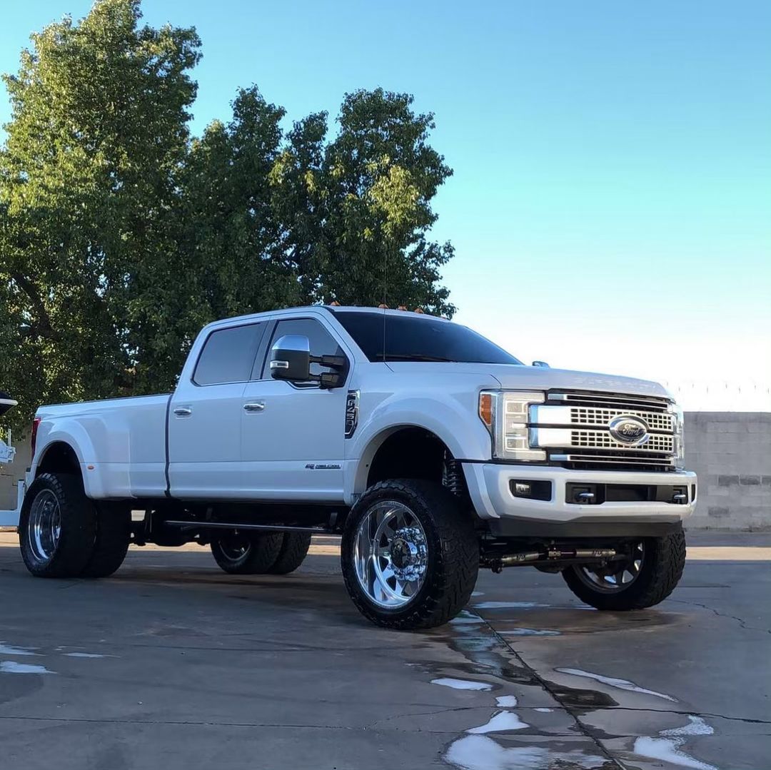 A white truck is parked on the side of the road.