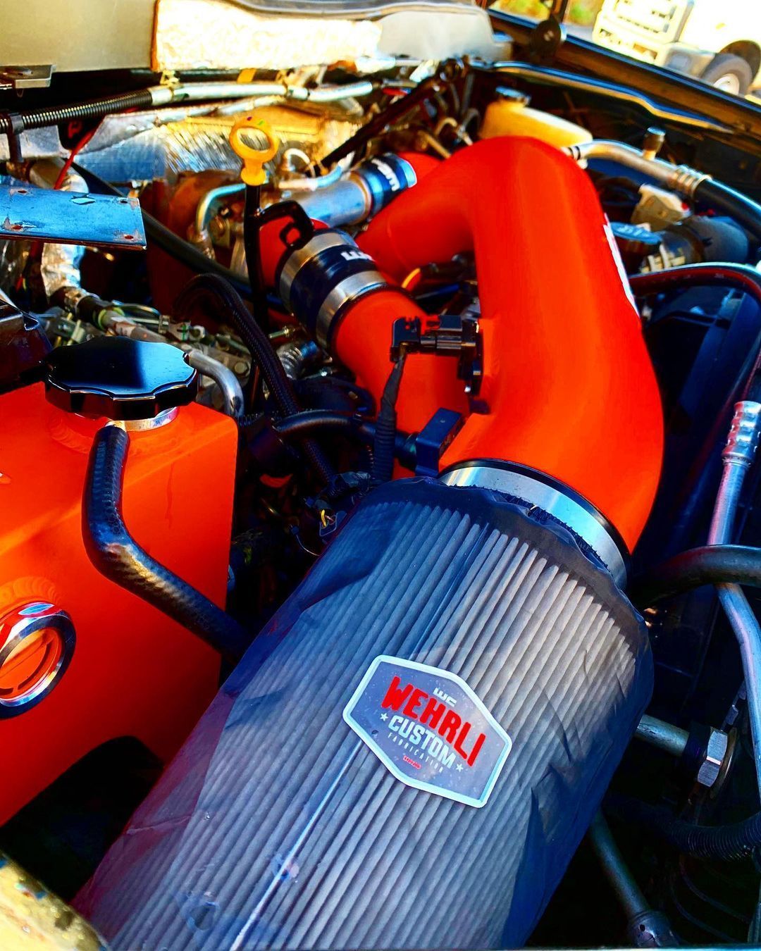 A close up of a car engine with a sticker that says ' merrill custom ' on it