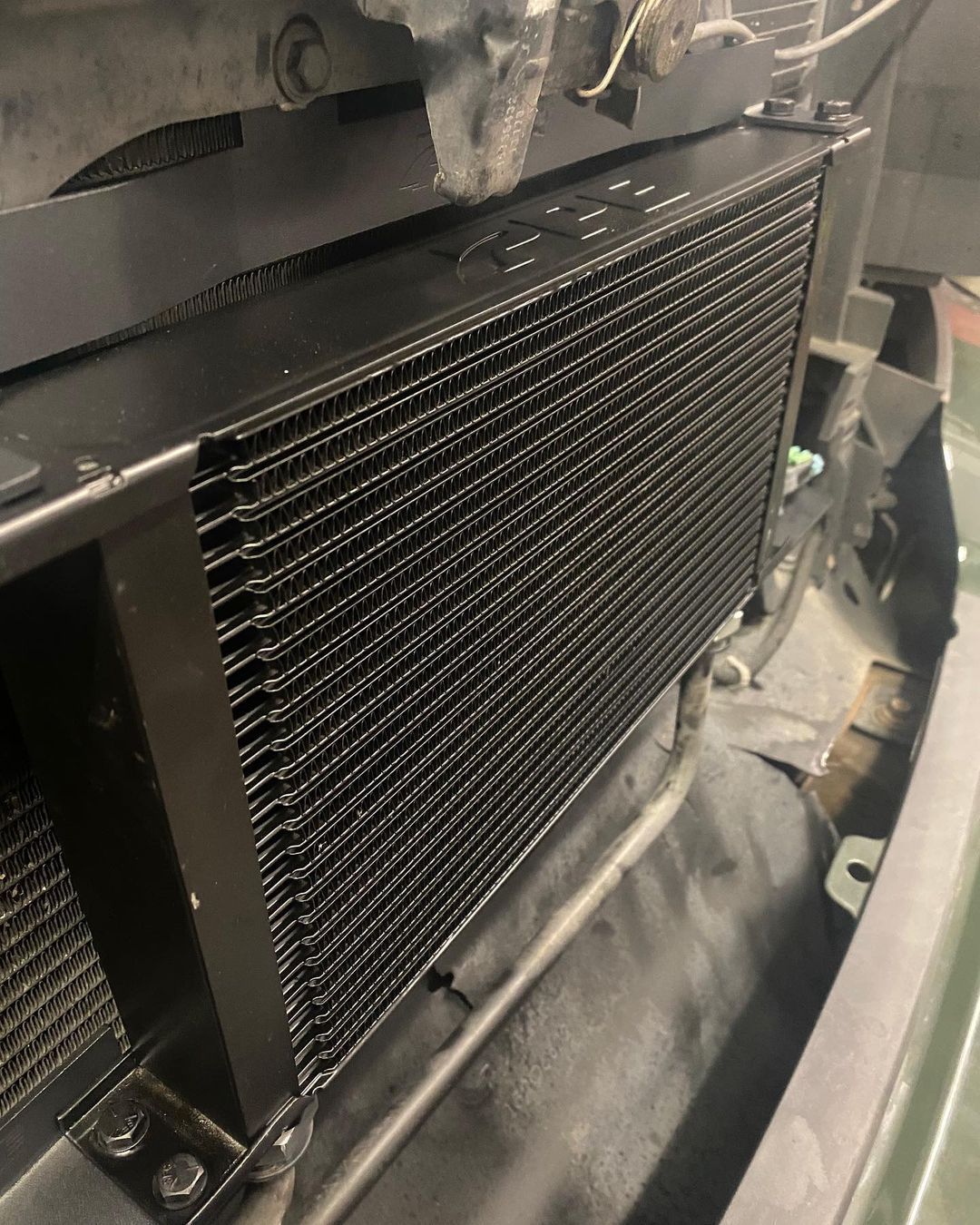 A close up of a radiator on the front of a car.