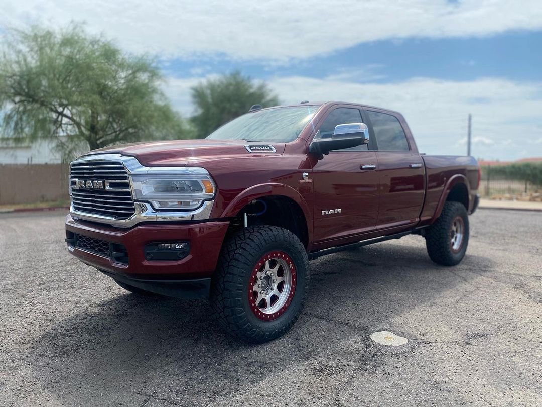 A red ram truck is parked in a parking lot.