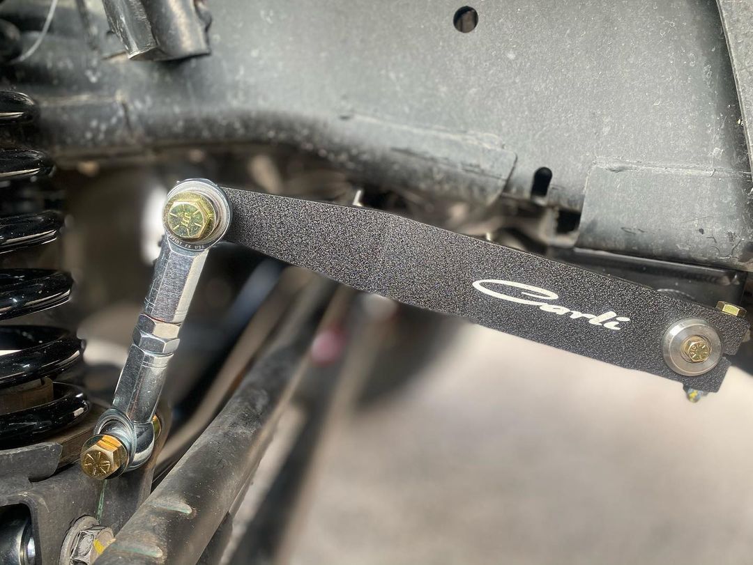 A close up of a suspension arm on a car.