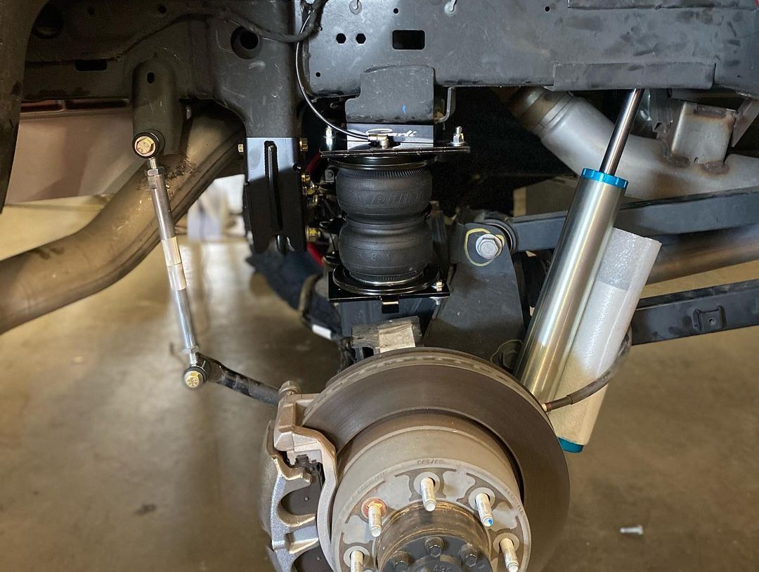 A close up of a car 's suspension and brake system