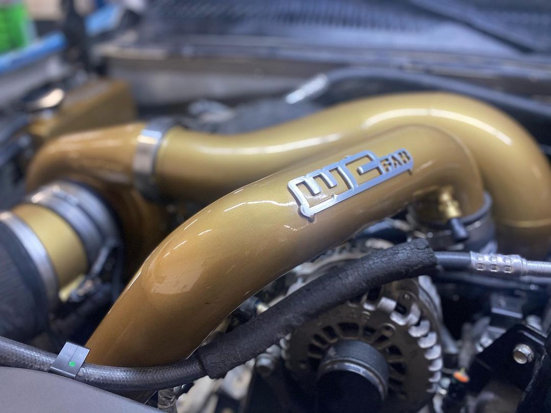 A close up of a car engine with a hose that says mg rad