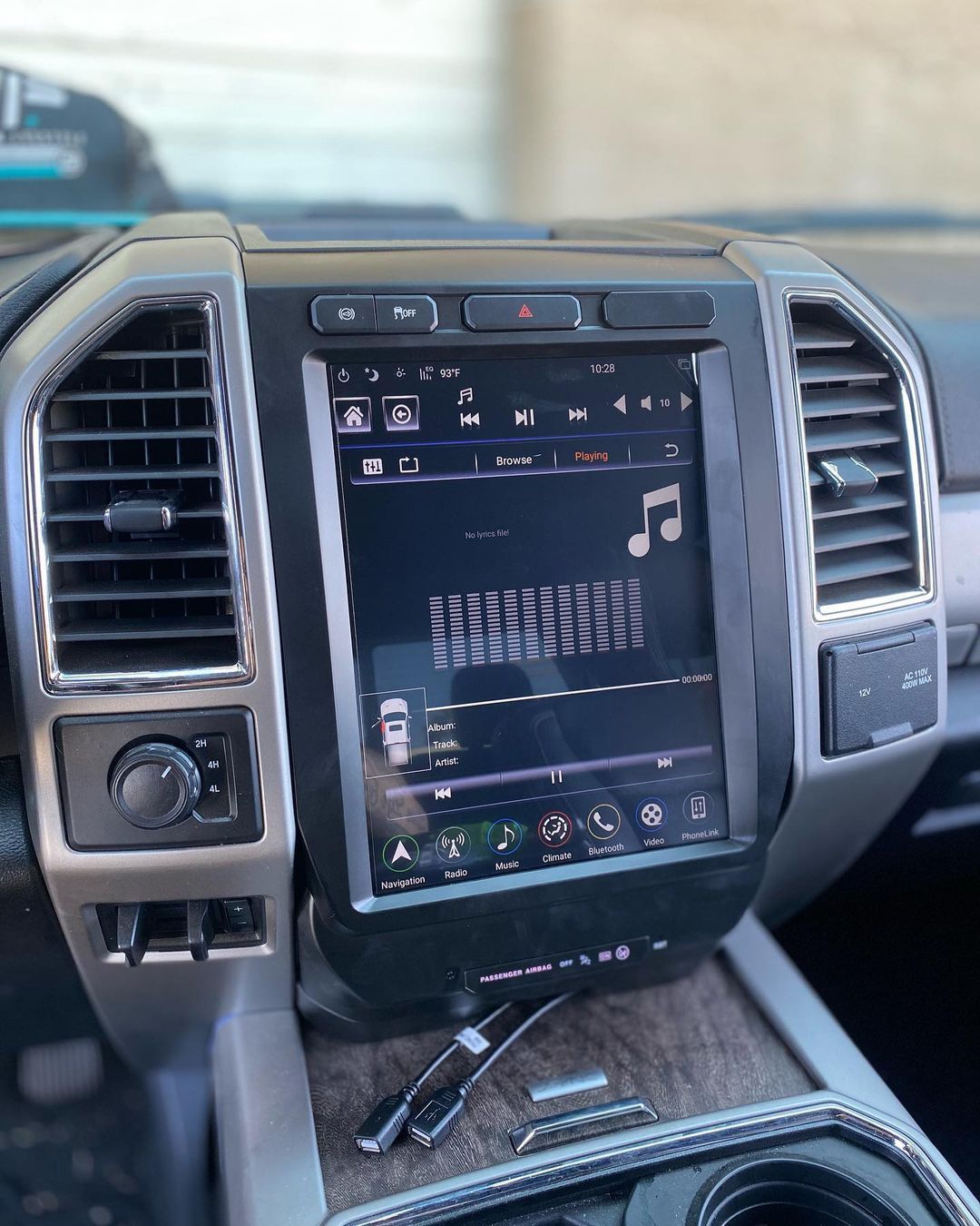 A close up of a car dashboard with a touchscreen display.