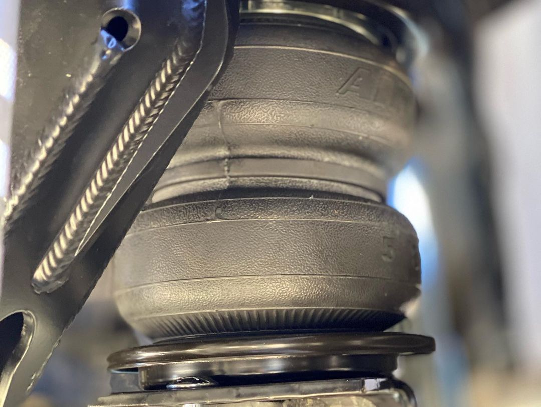 A close up of a metal object with a spring attached to it.