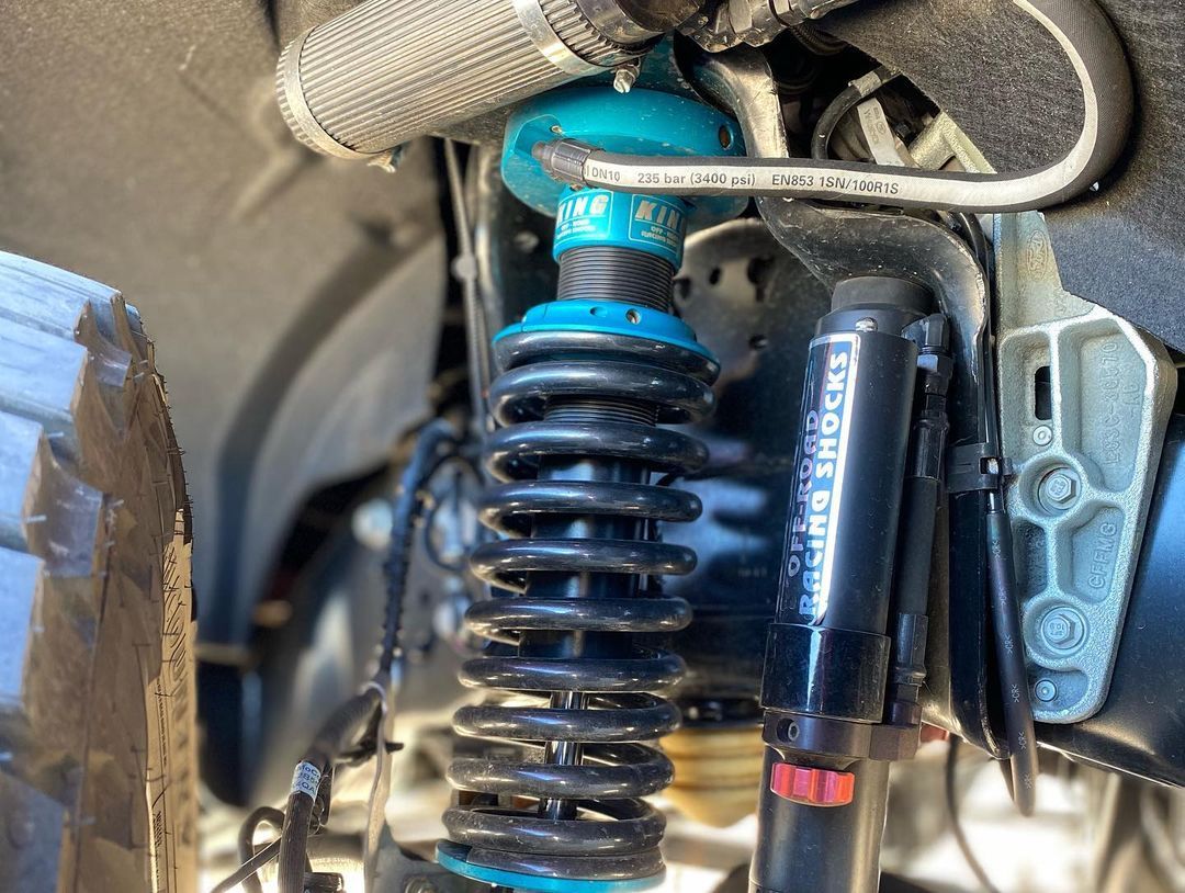 A close up of a shock absorber on a vehicle.