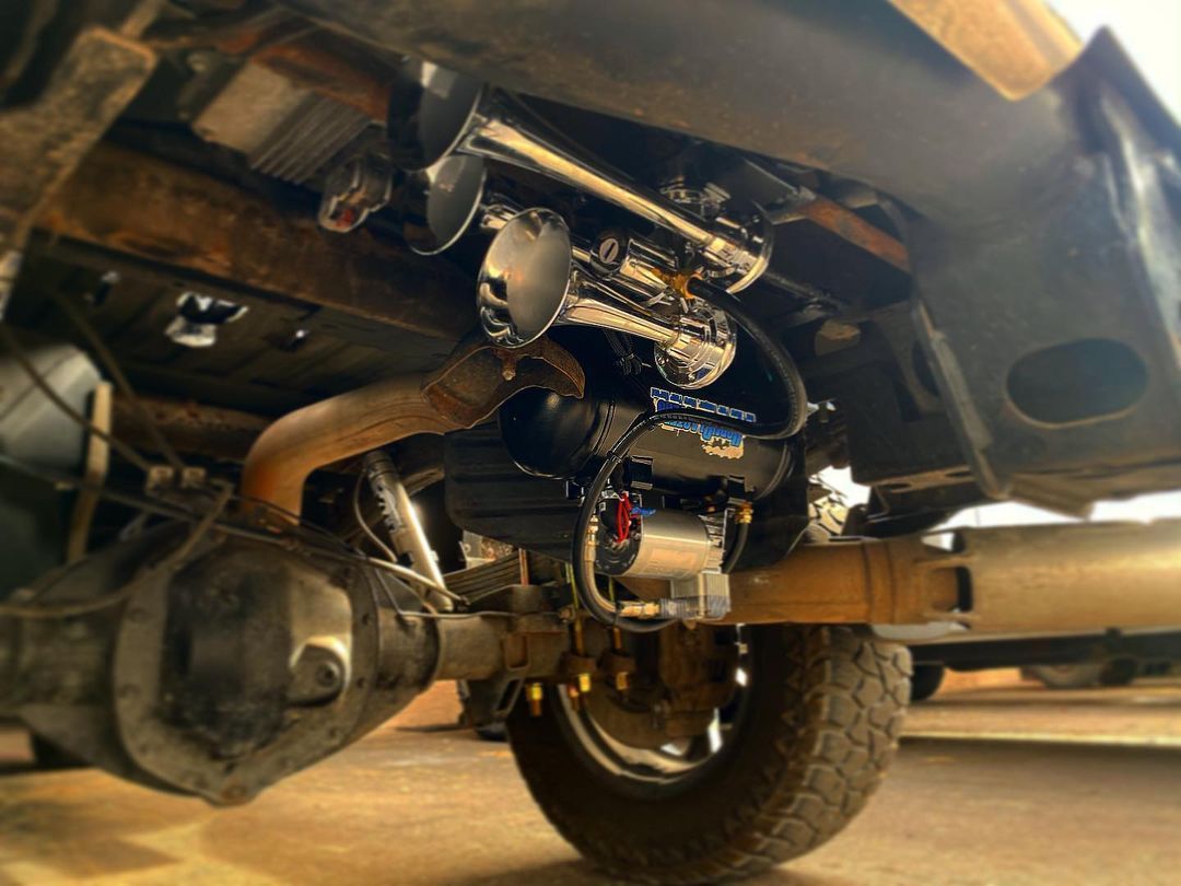 The underside of a truck with a horn on it