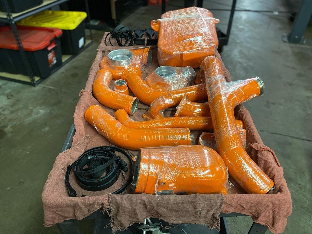 A bunch of orange pipes are sitting on a table.