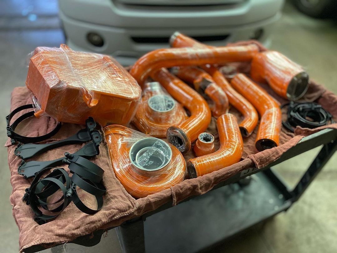 A bunch of orange pipes are sitting on top of a table.