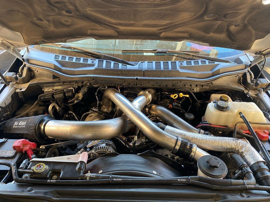 The engine of a truck is shown with the hood open.