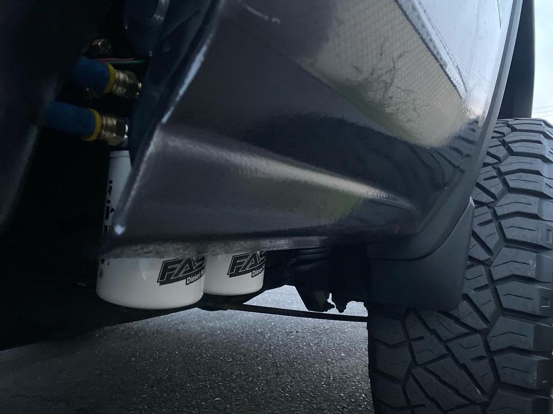 A close up of the underside of a truck with a fuel filter