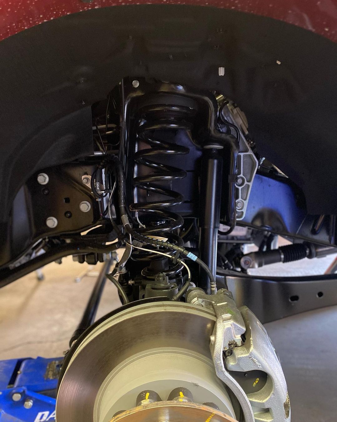 A close up of a car 's suspension and brake system