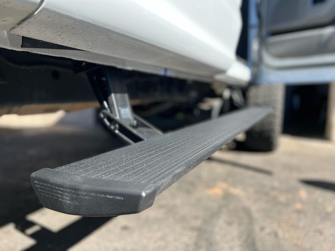 A close up of a side step on a white truck.
