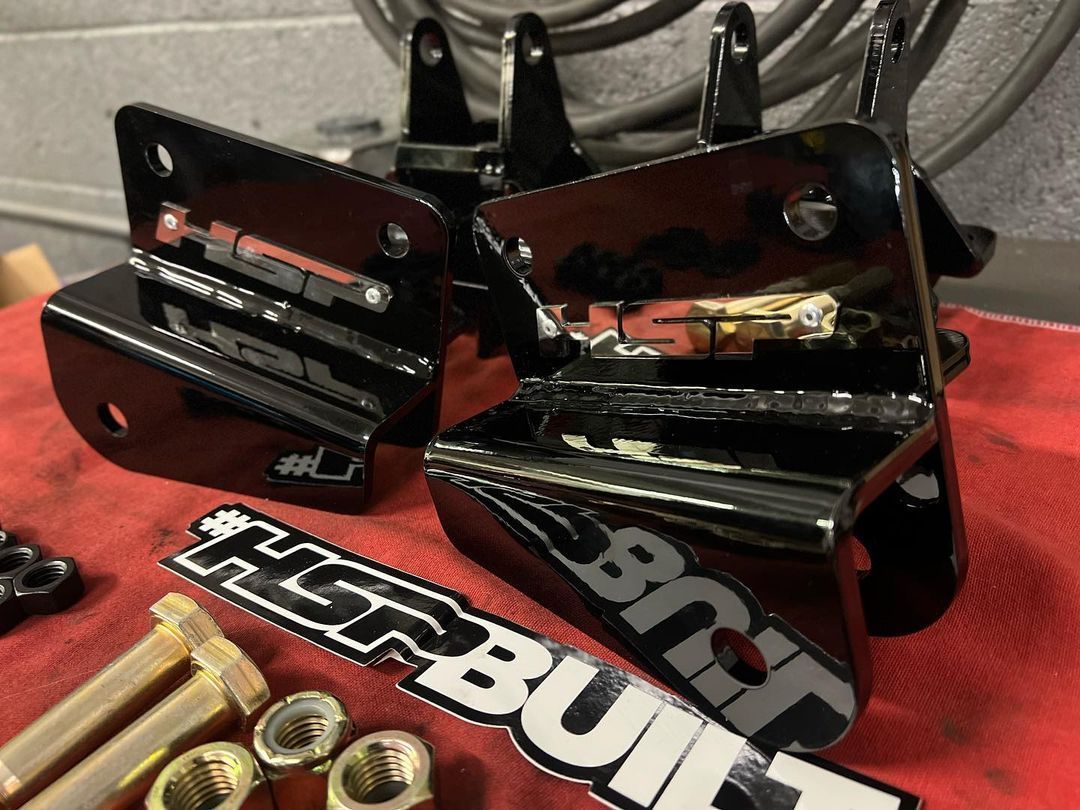 A pair of herbuilt brackets sit on a red cloth