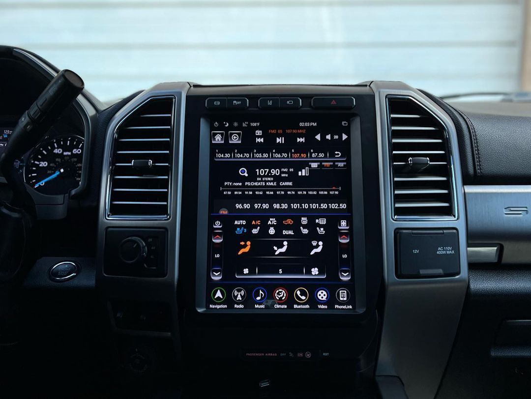 A close up of a car dashboard with a touchscreen display