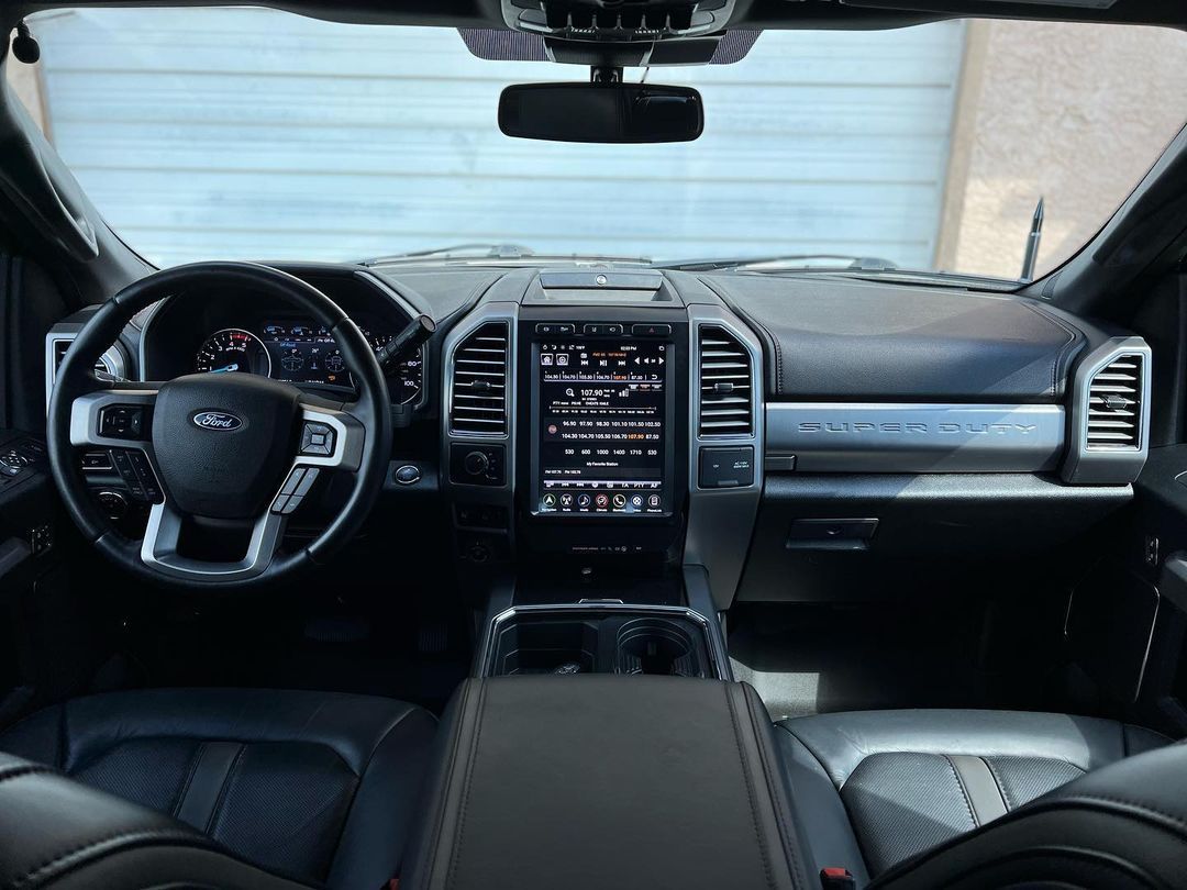The interior of a ford truck with a steering wheel and dashboard