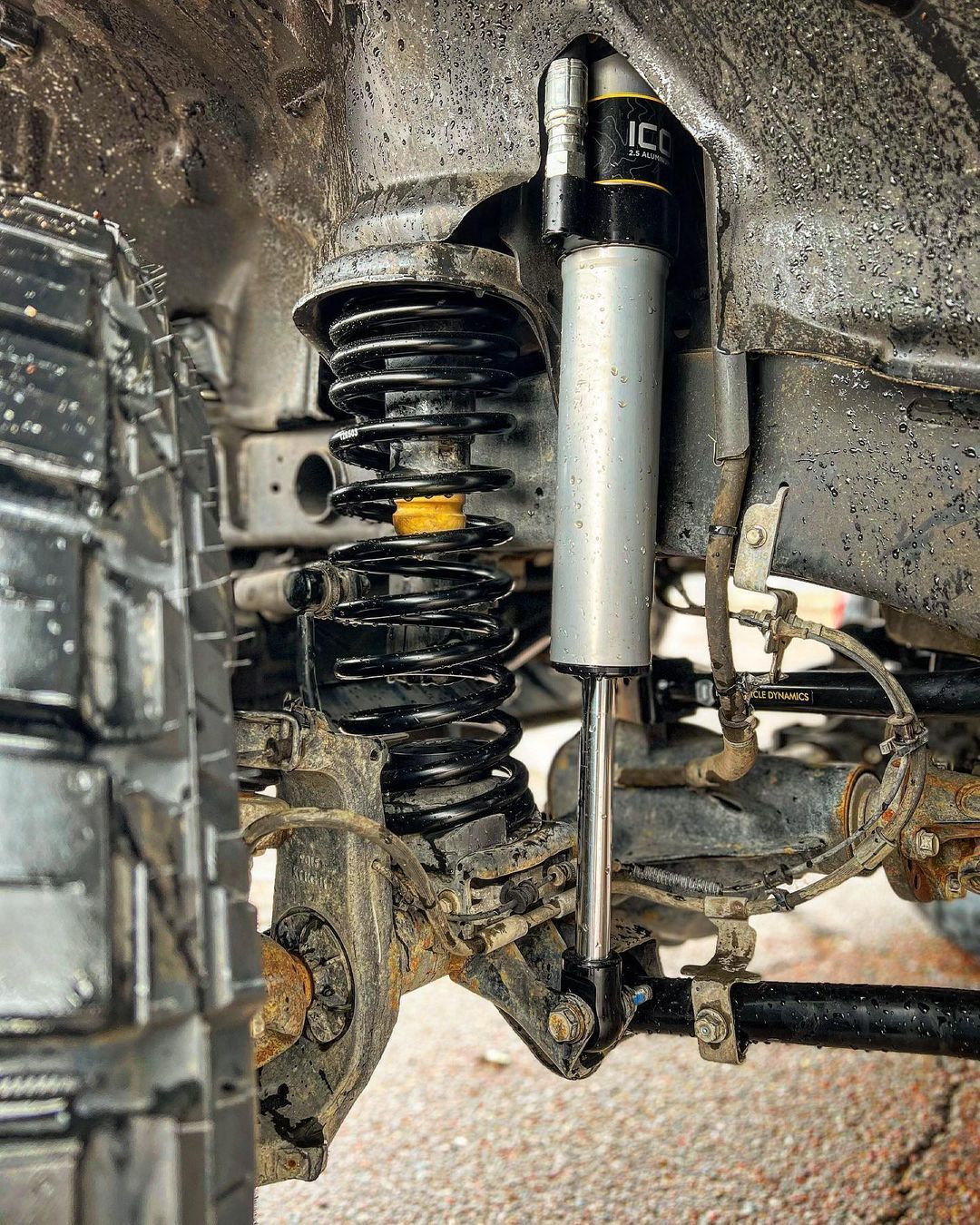 A close up of a shock absorber on a truck.