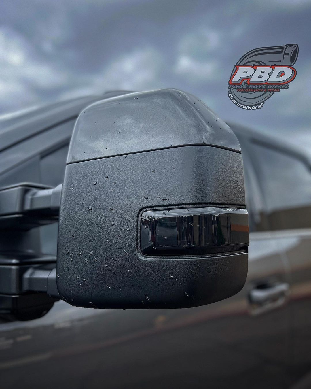 A close up of a side view mirror on a truck