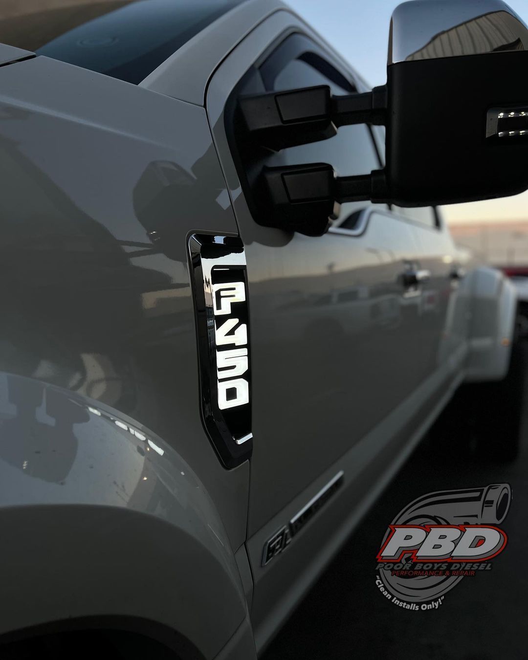 A silver truck with the word lone on the side