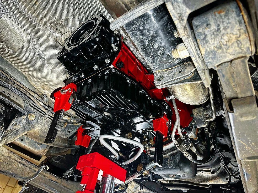 A close up of the underside of a car engine.