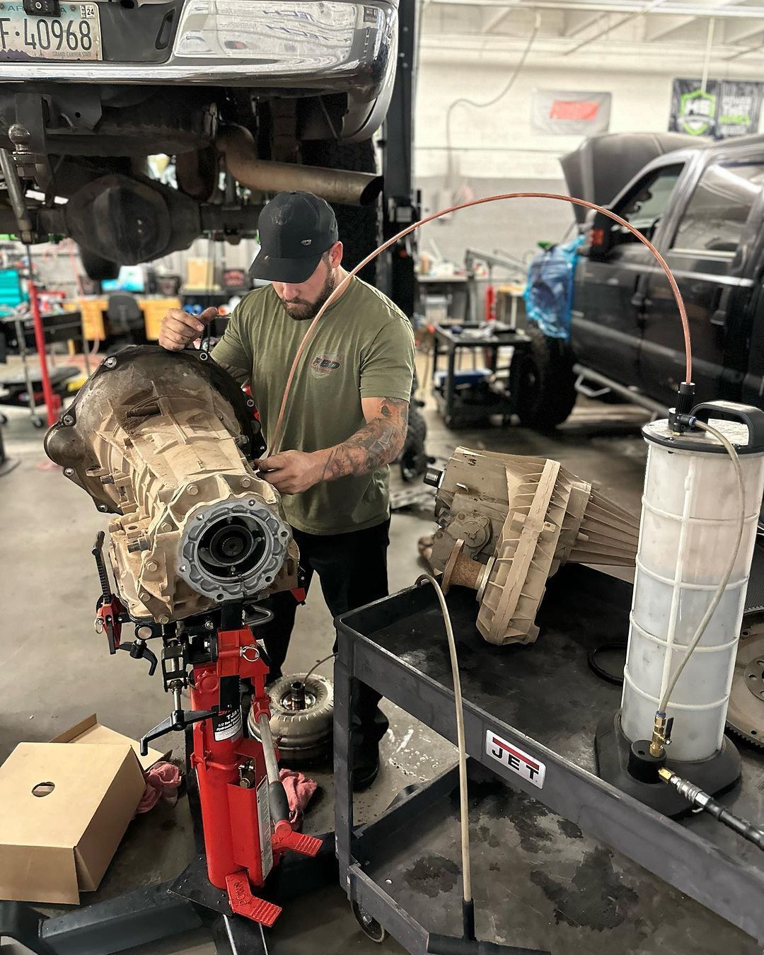 A man is working on a truck engine in a garage.