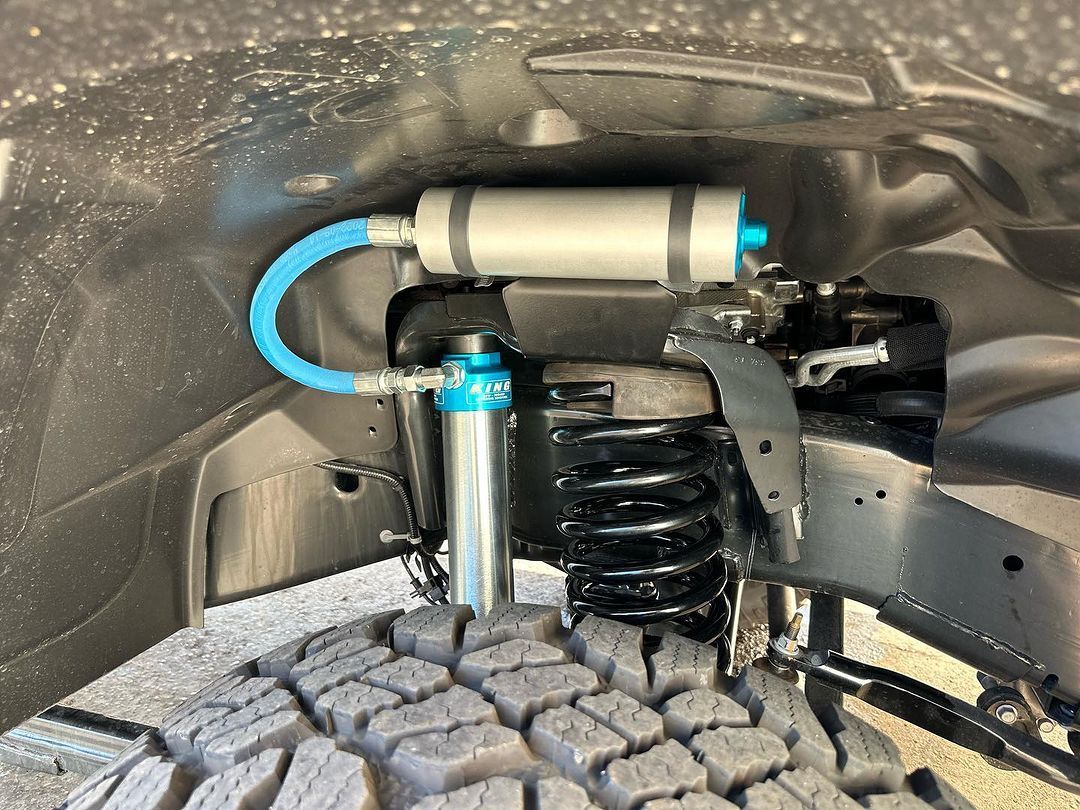 A close up of a suspension system on a truck.