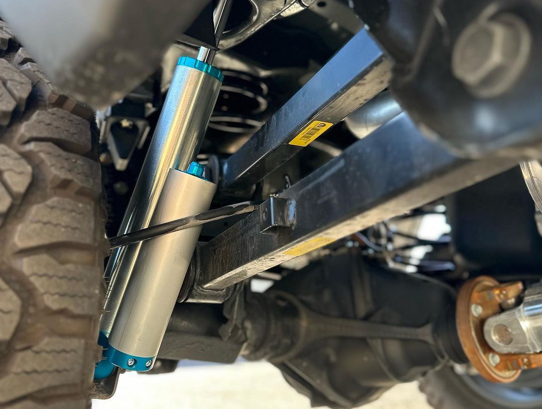 A close up of a suspension system on a truck.