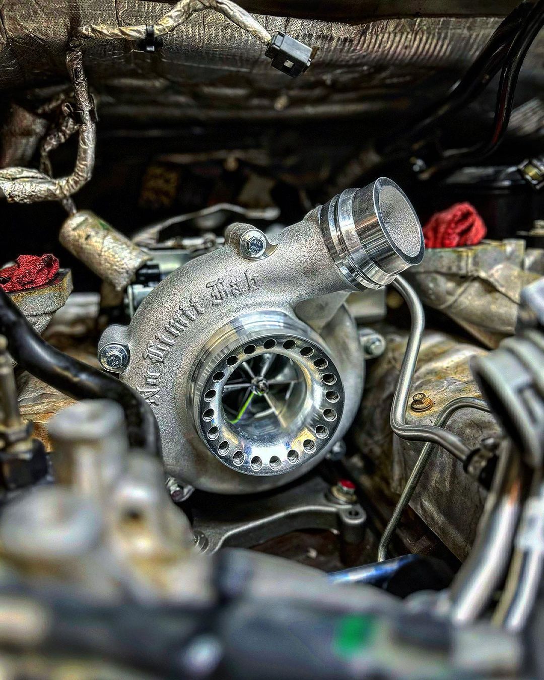 A close up of a turbocharger in a car engine.