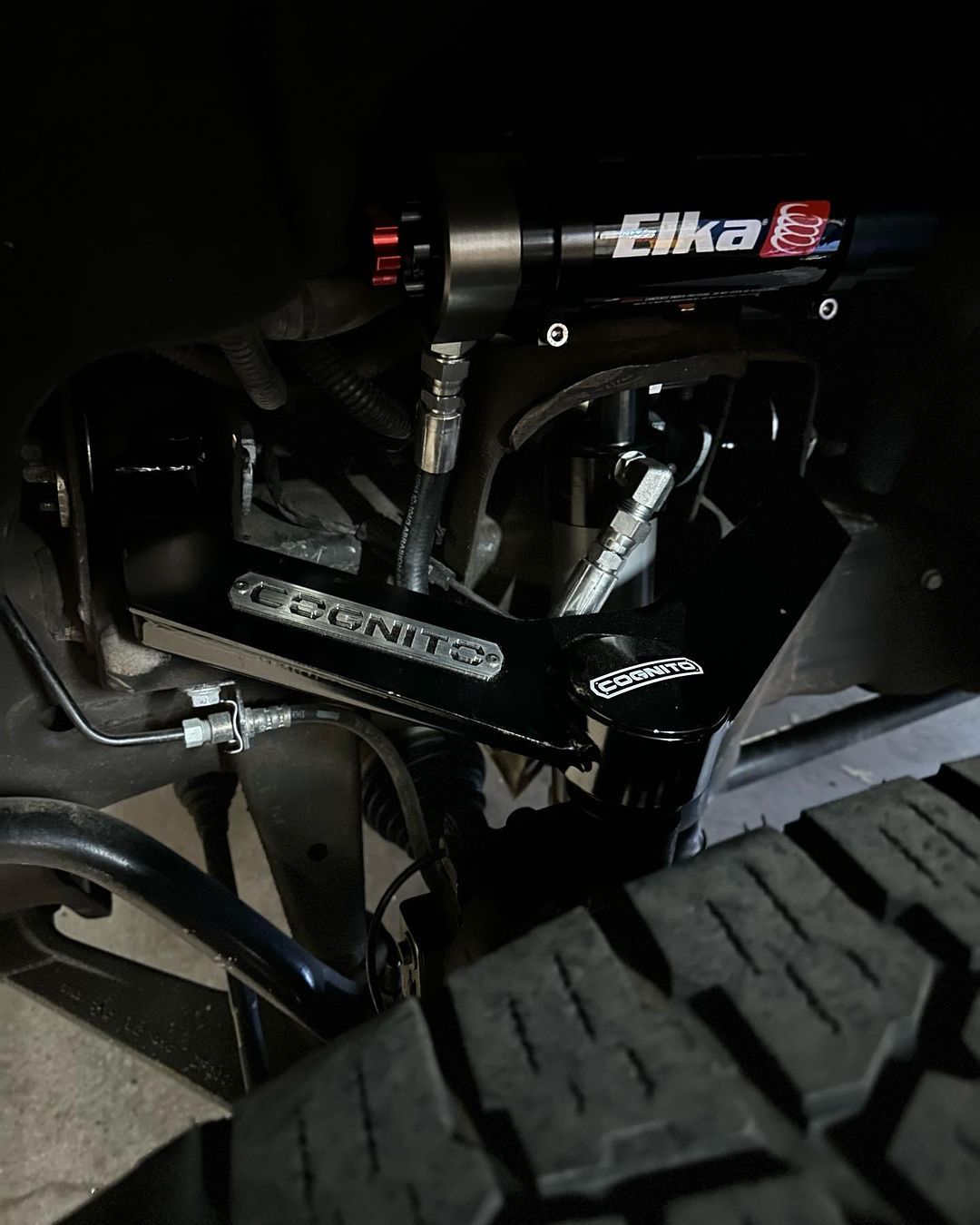 A close up of a suspension system on a truck.