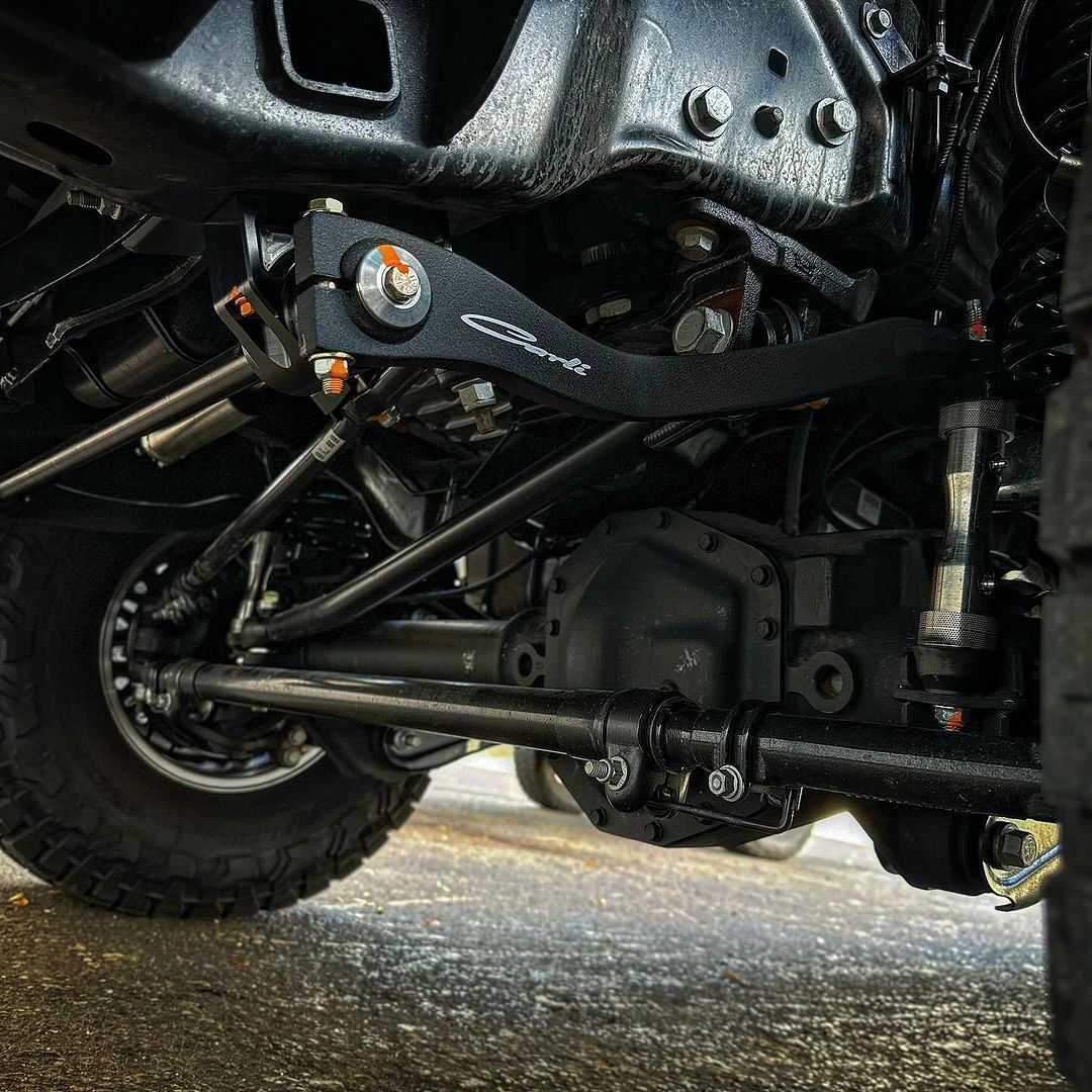 A close up of the underside of a truck 's suspension system.