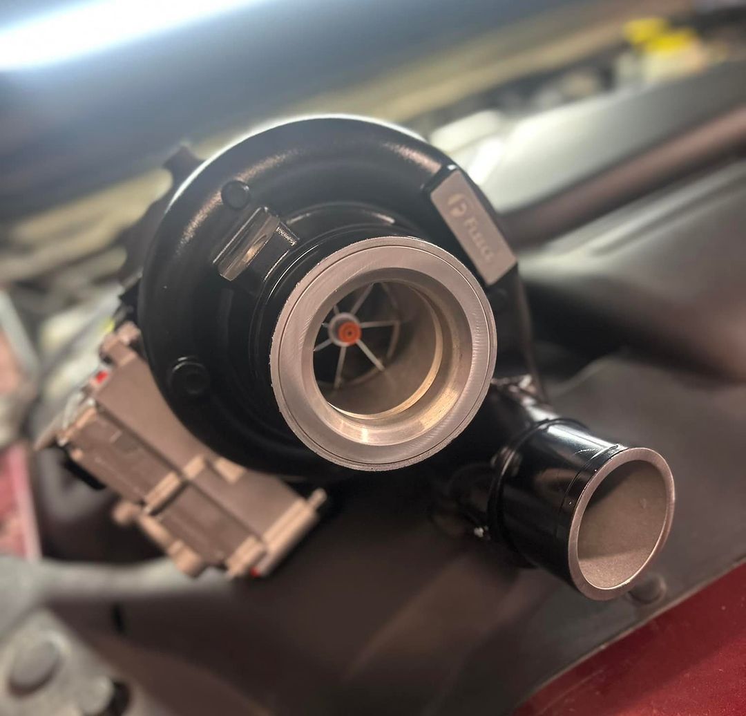 A turbocharger is sitting under the hood of a car