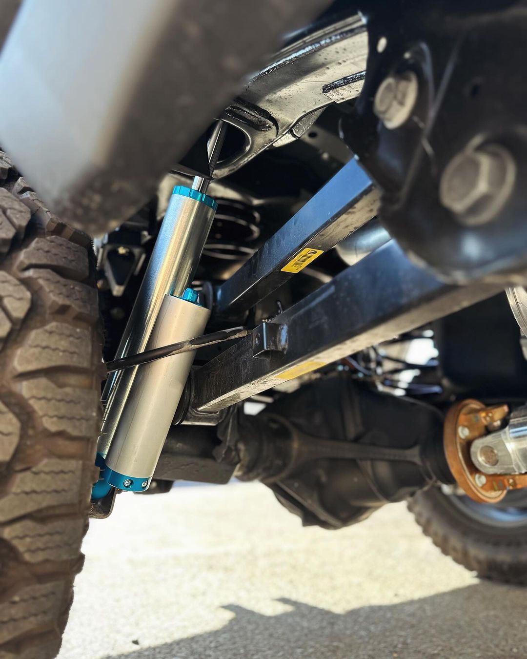 A close up of a suspension system on a truck.