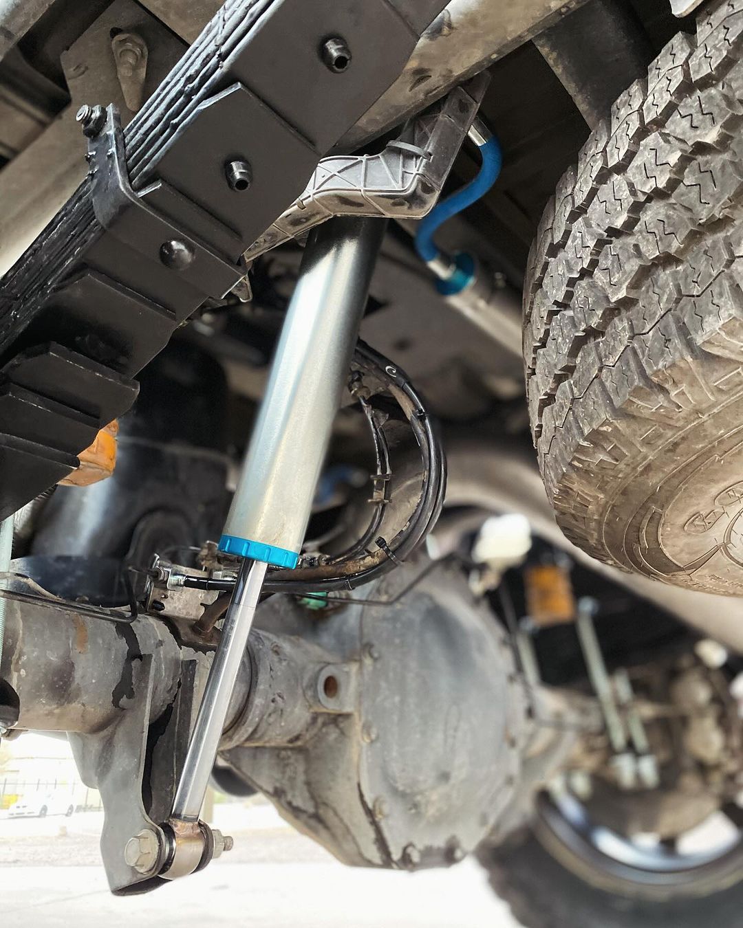 A close up of a shock absorber on a truck