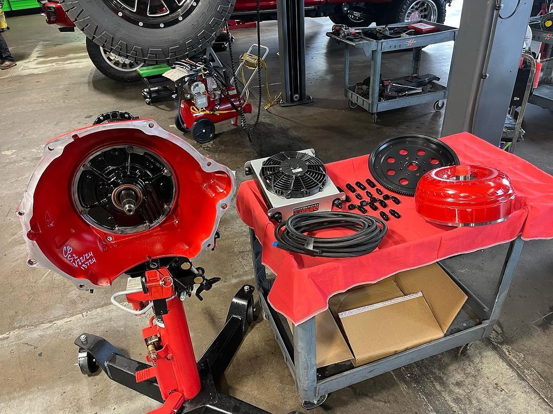 A table with a red table cloth on it in a garage.