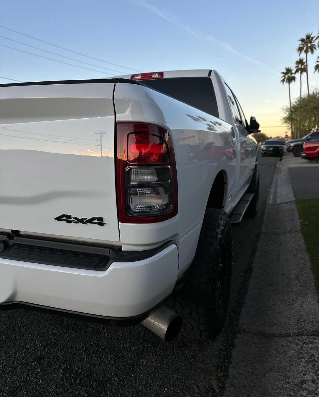 A white truck is parked on the side of the road.