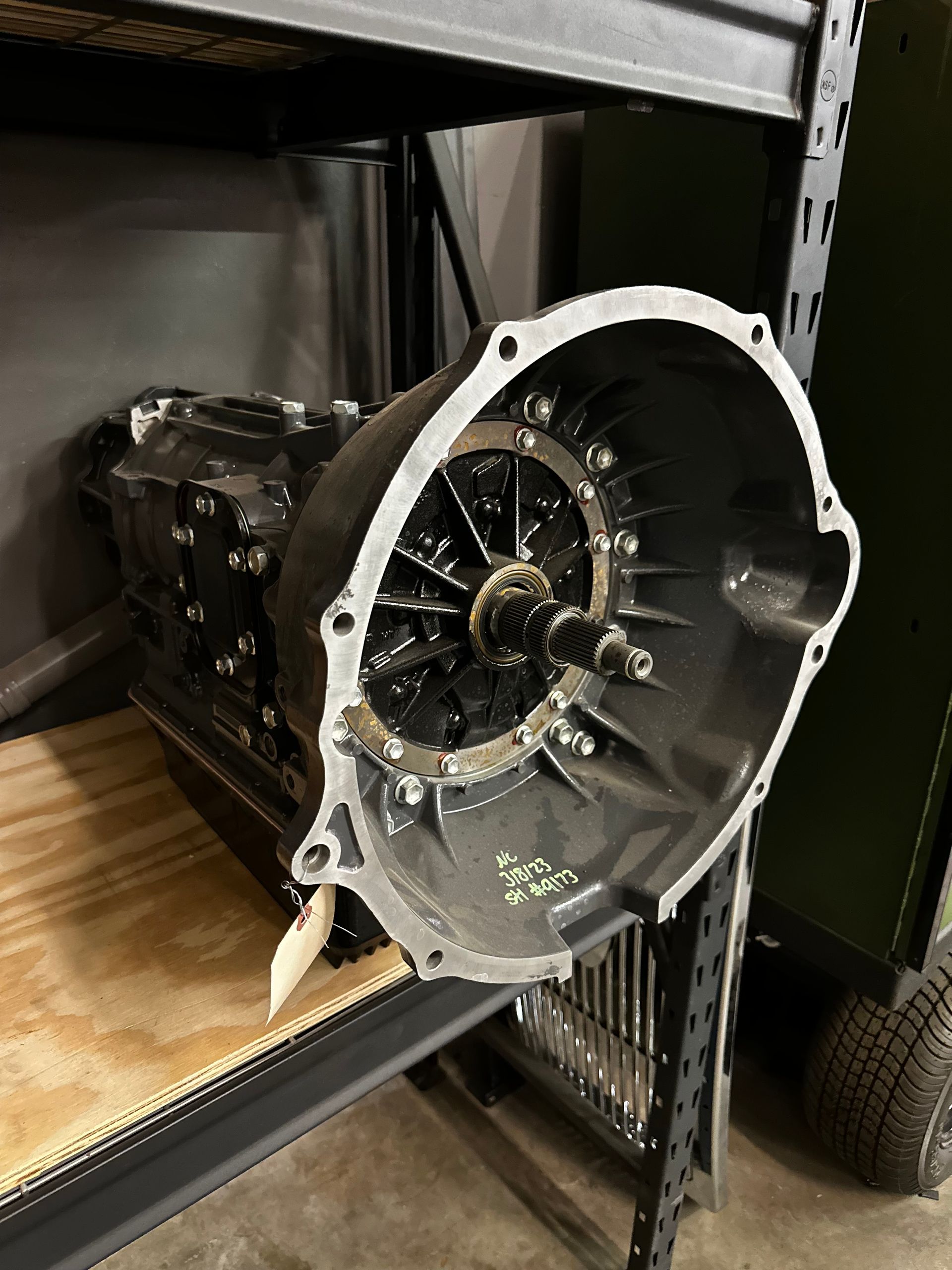A gearbox is sitting on top of a wooden table.