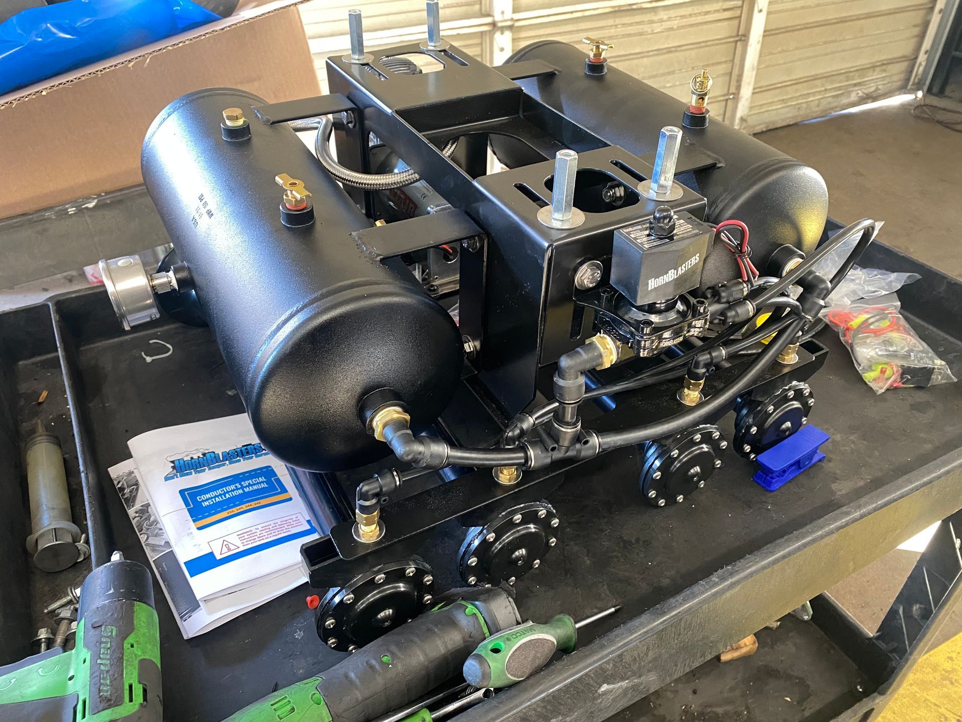 A black machine is sitting on top of a black table.