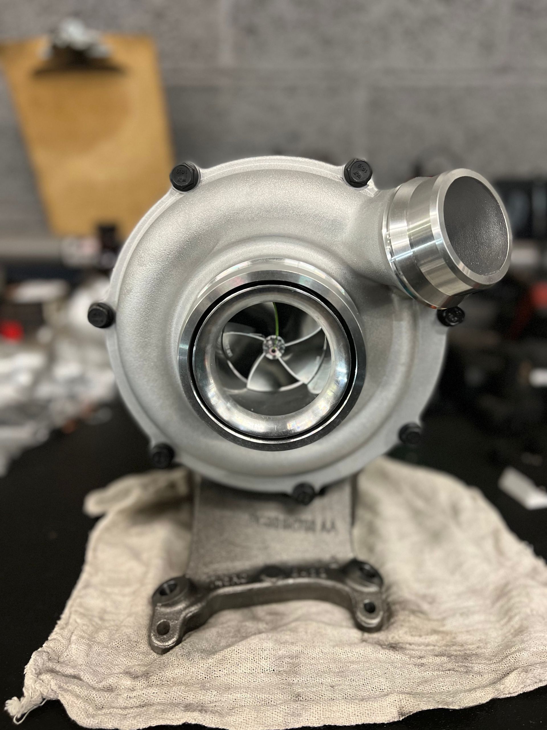 A turbocharger is sitting on a towel on a table.
