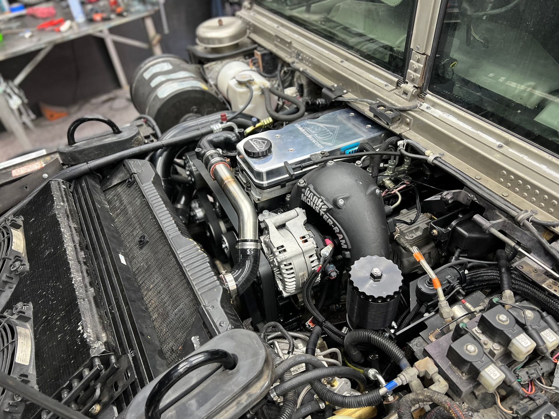 A close up of a car engine with a lot of wires coming out of it.
