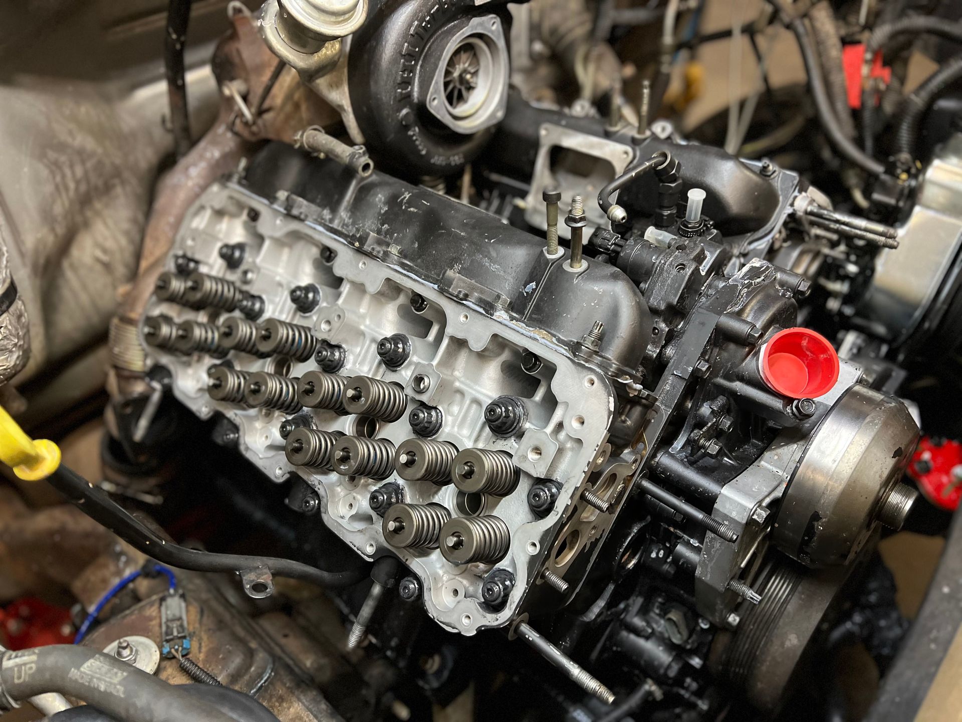 A close up of a car engine that is being worked on.