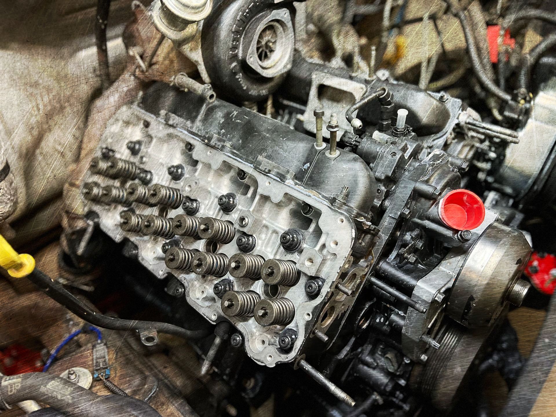 A close up of a car engine being worked on.