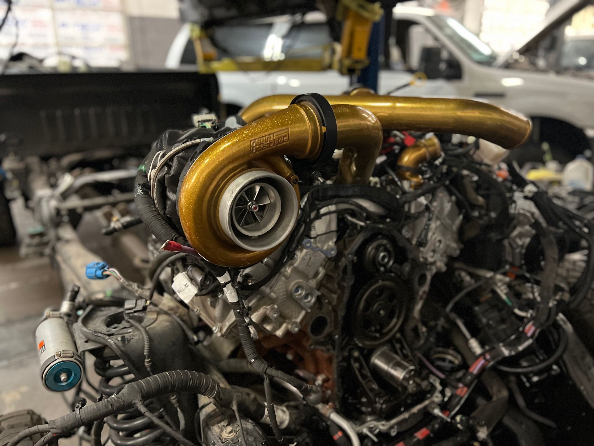 A close up of a car engine with a turbocharger on it.