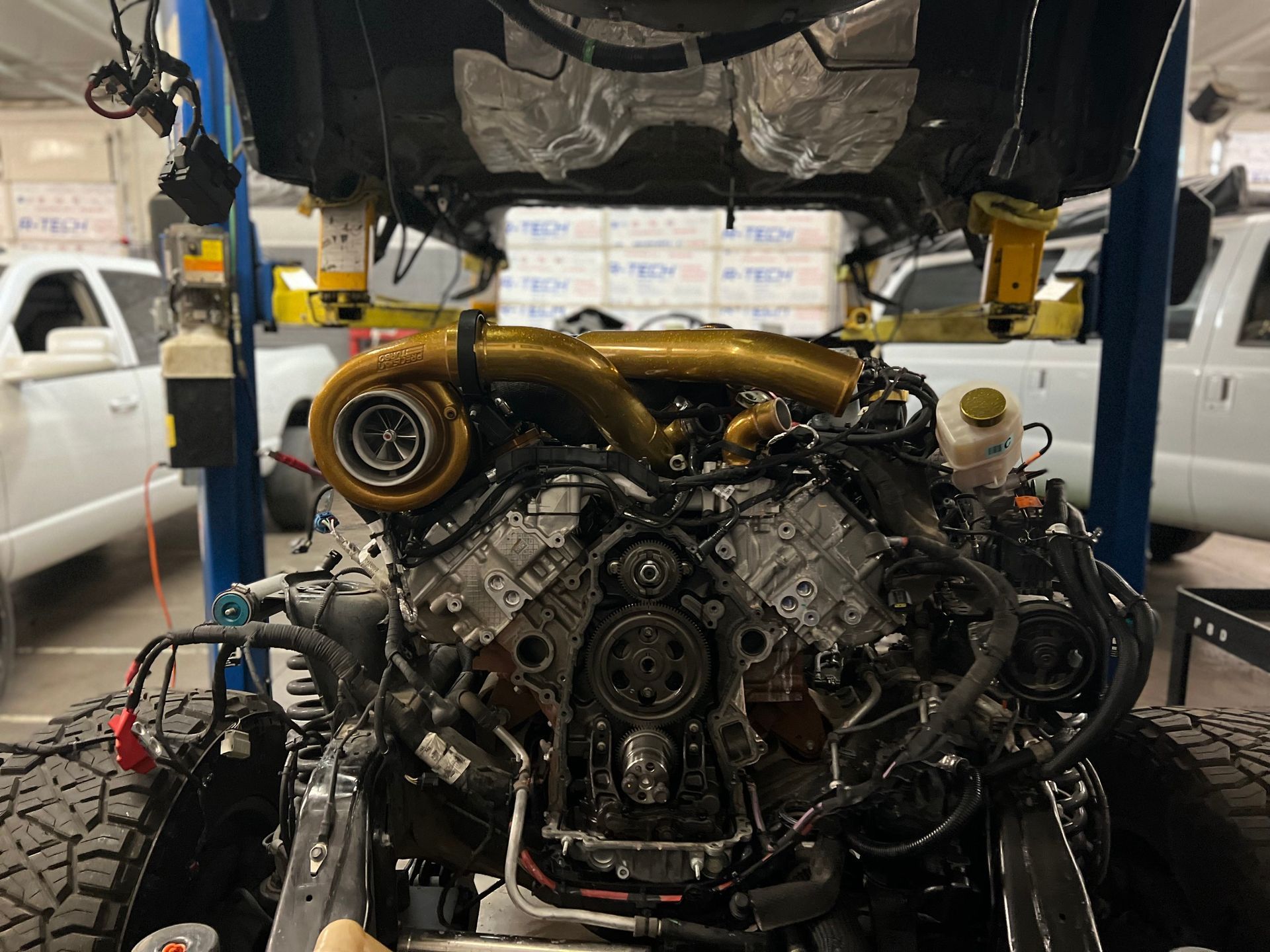 A car engine is being worked on in a garage.