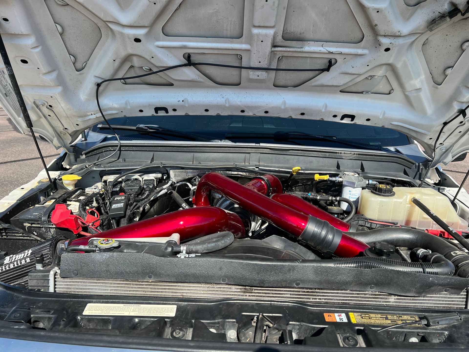 The hood of a car is open and the engine is visible