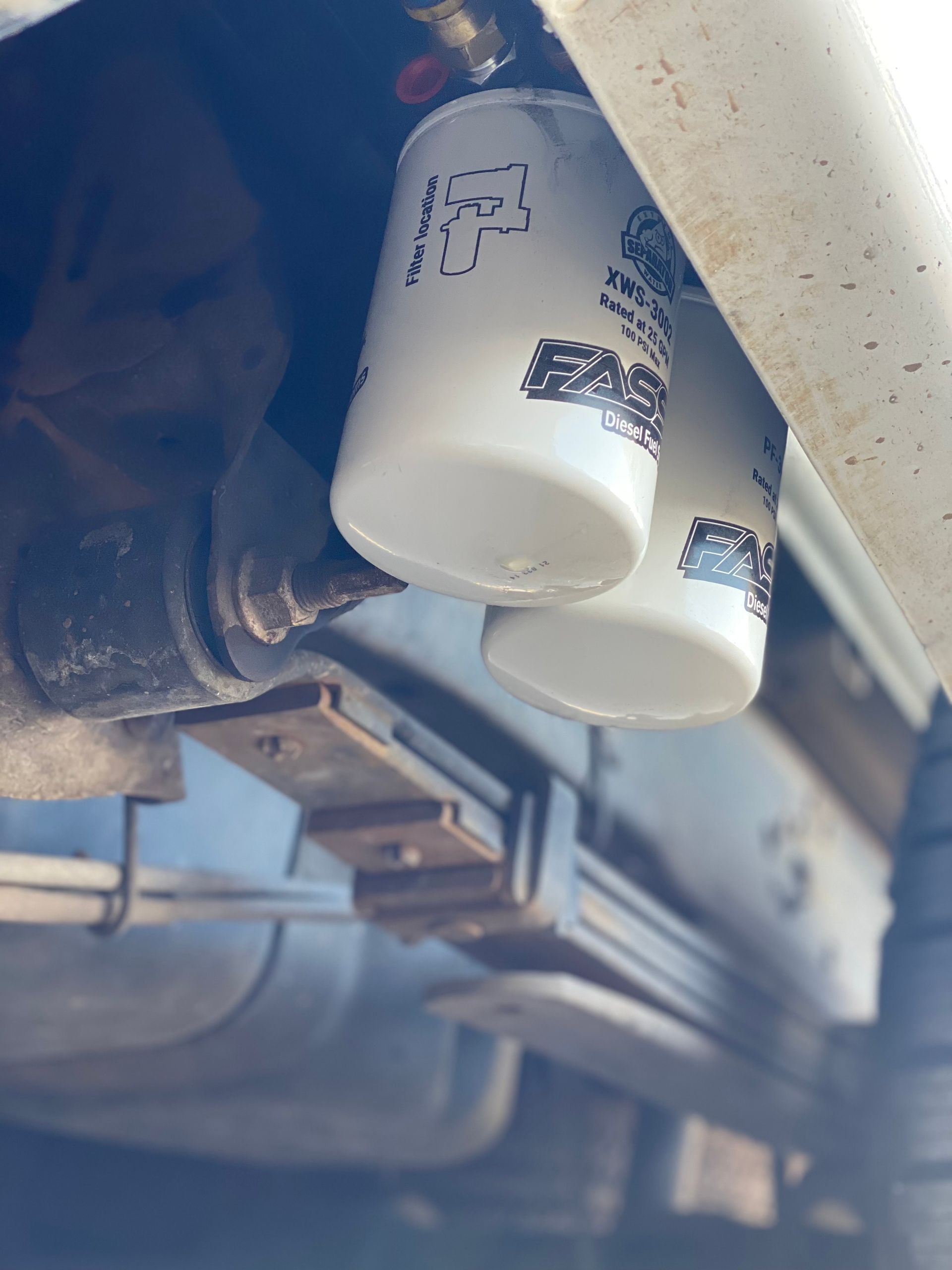 A close up of two oil filters on a car