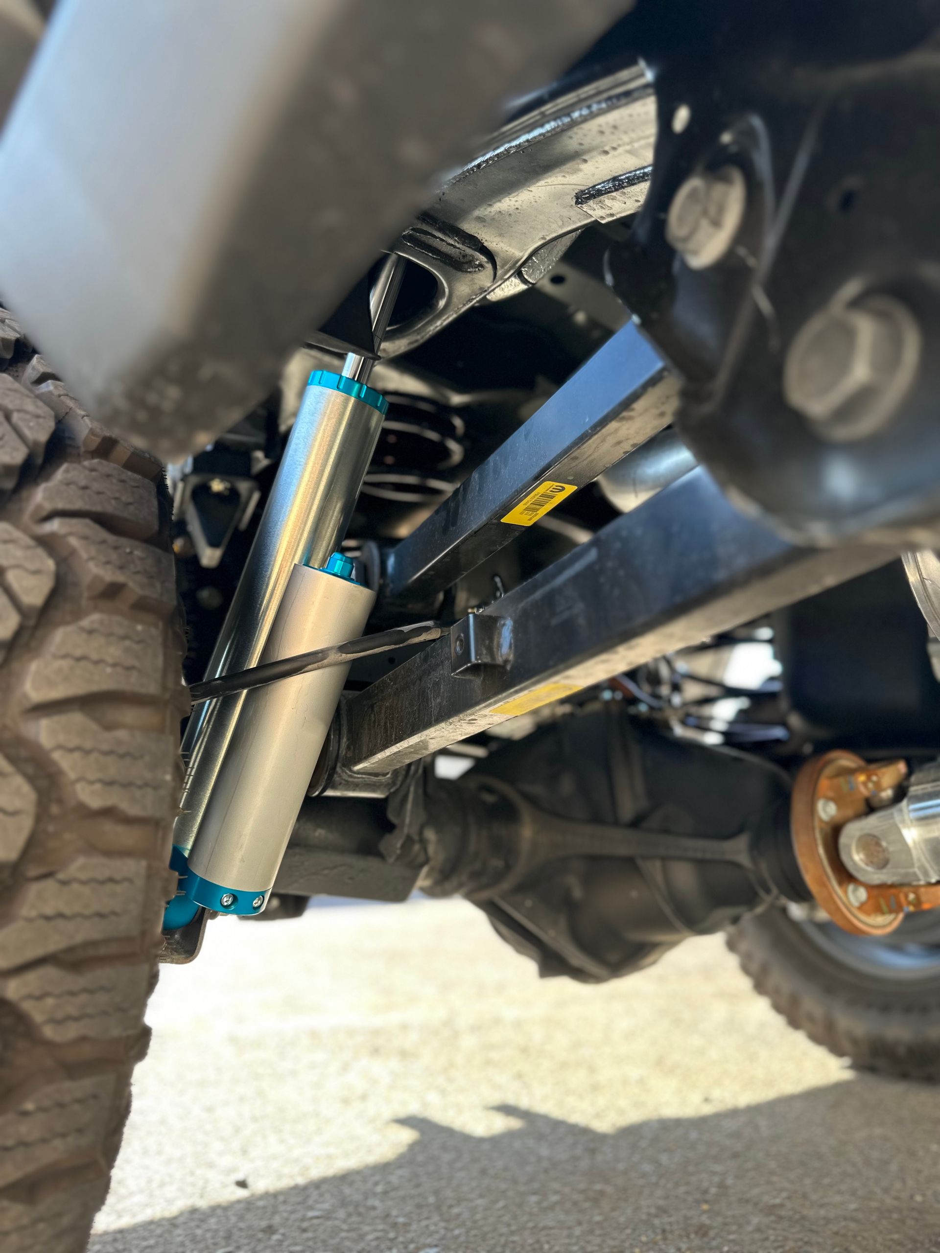 A close up of a suspension system on a truck.