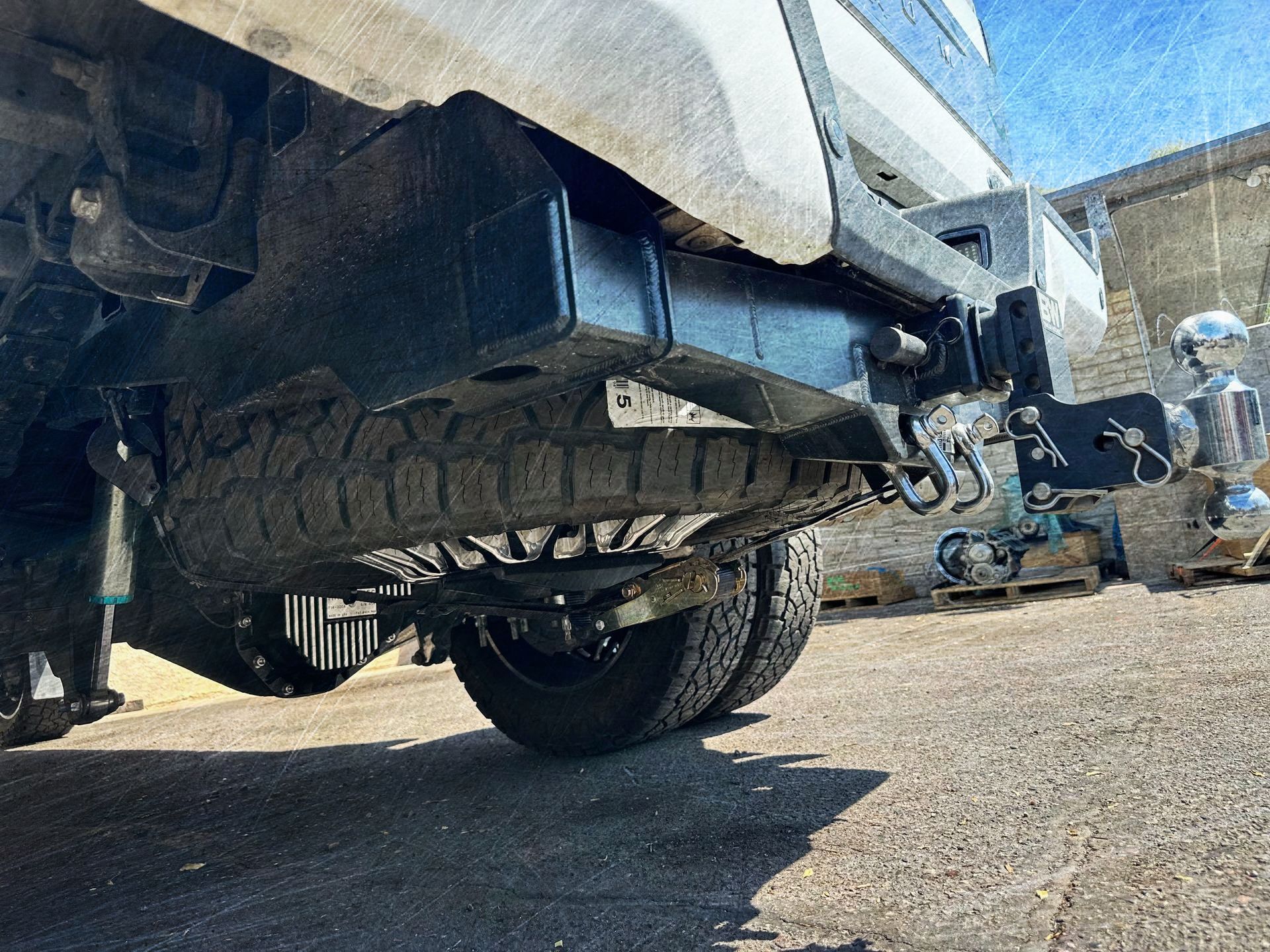 A truck is parked on the side of the road in a parking lot.