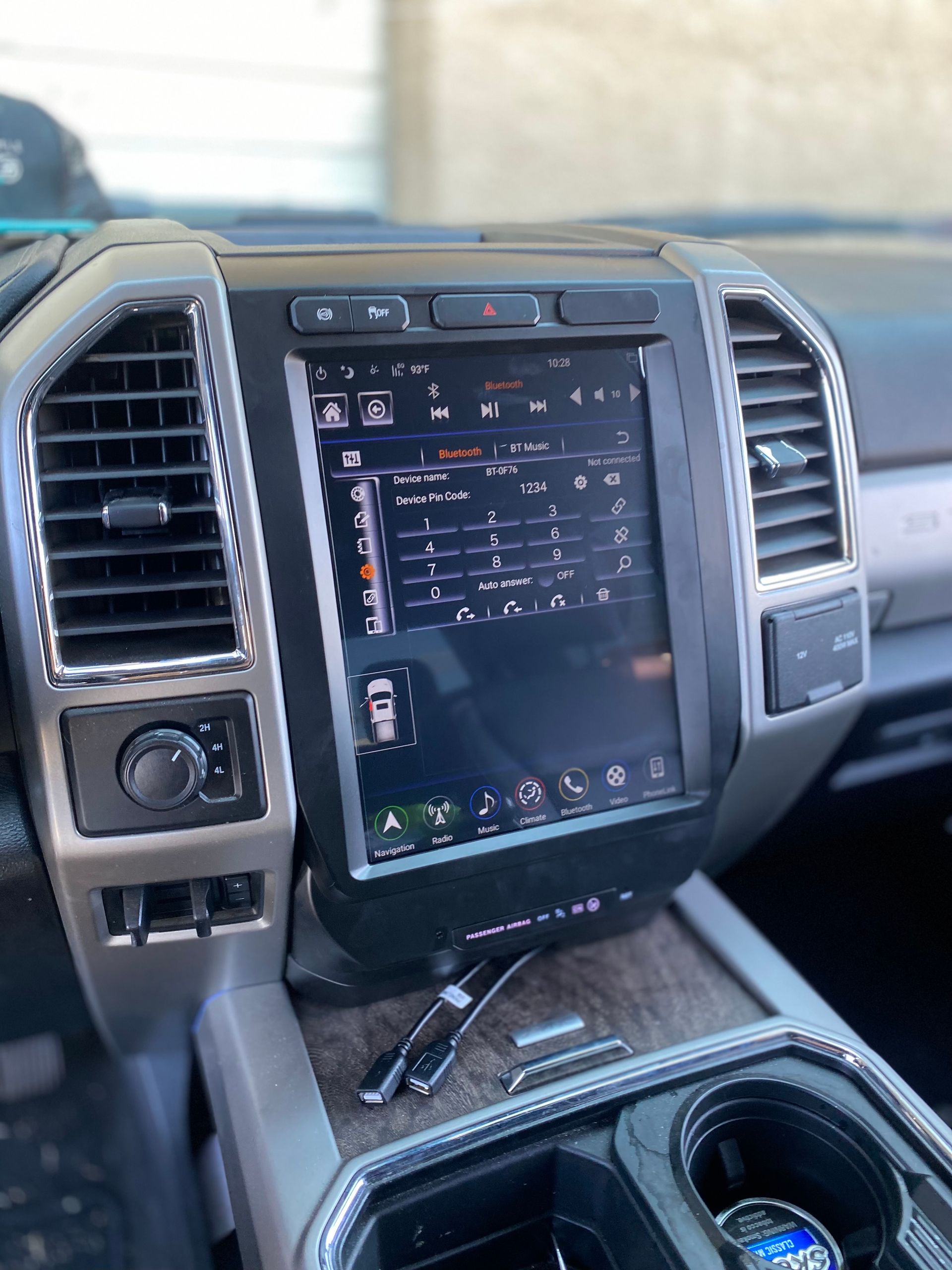 The dashboard of a ford truck with a tablet on it.