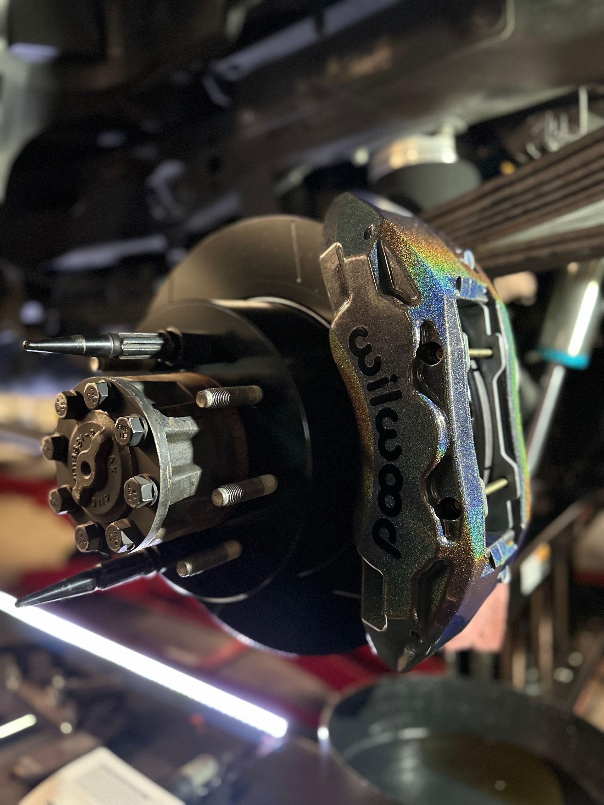 A close up of a wilwood brake caliper on a car