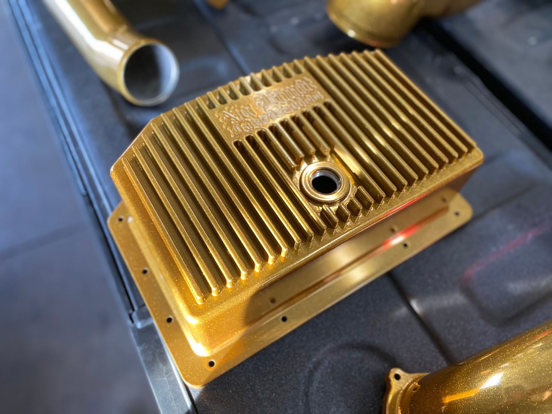 A gold colored metal item with a hole in the middle